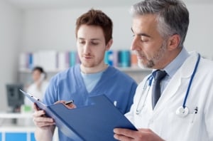 Doctor and nurse consulting a chart